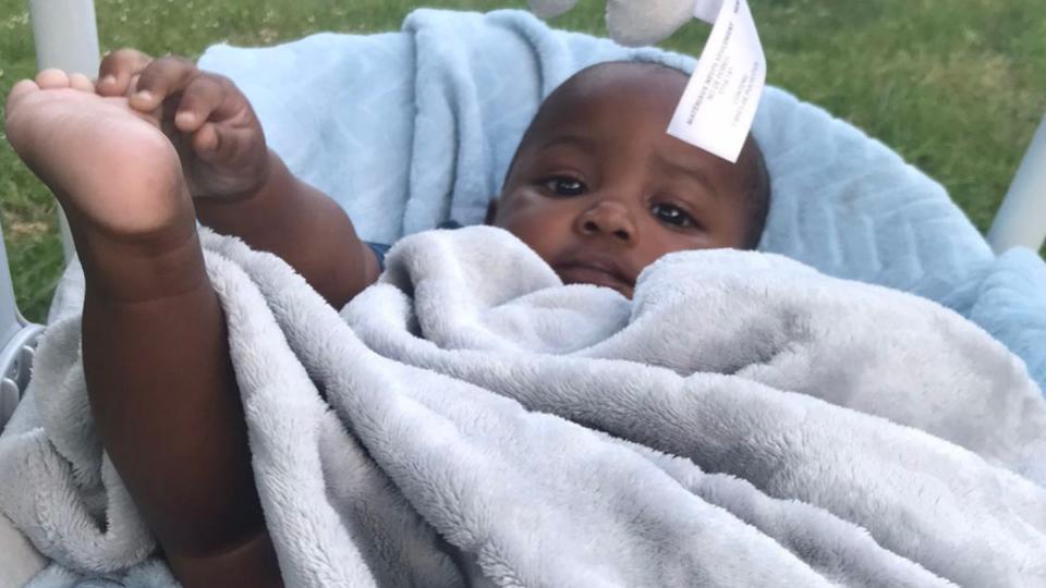 Azaiah, with a blanket on him and his foot up in the air.