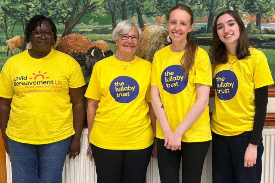 Four volunteers, three The Lullaby Trust T-shirts and a bereavement UK volunteer at the family day at Colchester zoo 2025