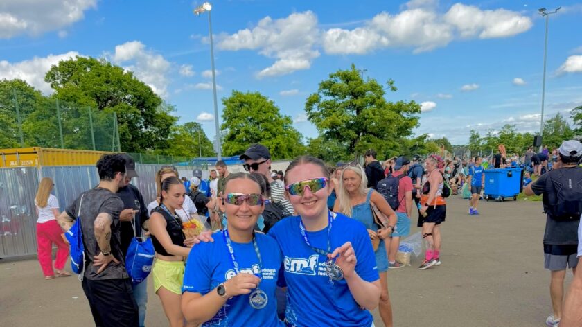 Two women in blue finishers tshirts