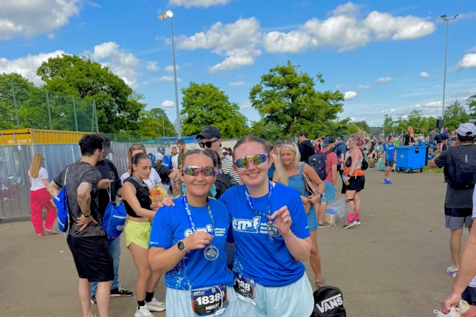 Two women in blue finishers tshirts