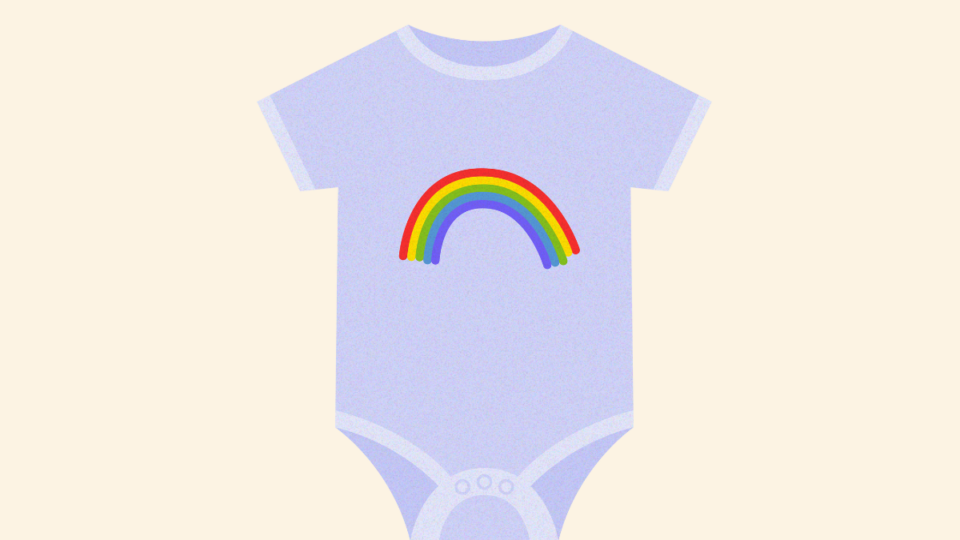 A babygrow with a rainbow on it.