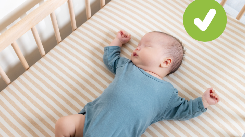 Baby sleeping on their back in a cot. A green tick in the top right corner.