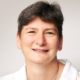 A professional headshot of Dr Joanna Garstang. She has short, dark hair, wears a white blouse, a silver necklace and is smiling.