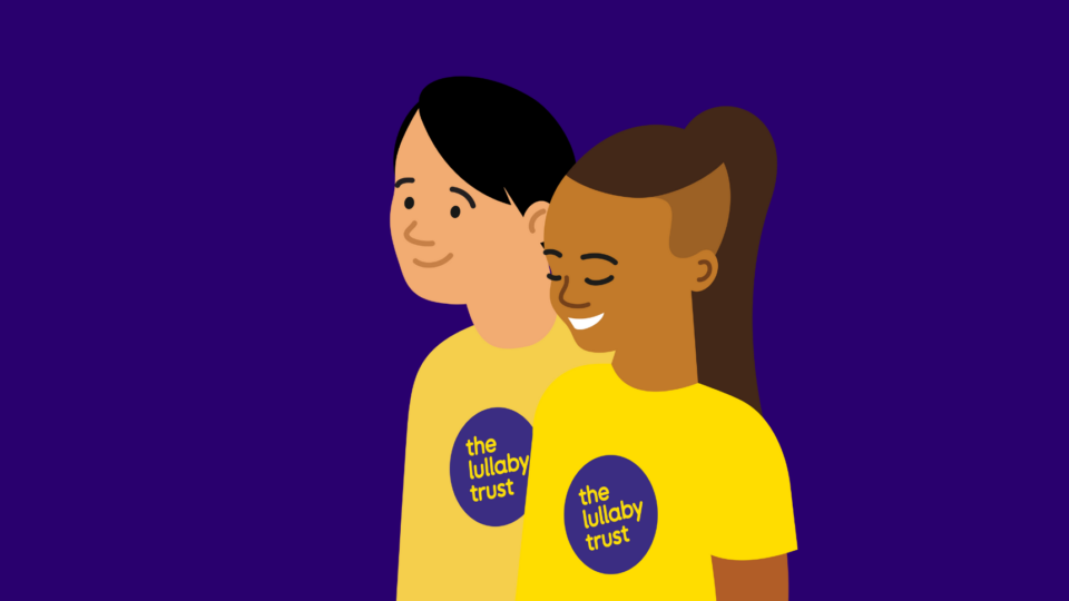 Illustration of two people wearing Lullaby Trust t-shirts. One has medium-dark skin, and the other fair. They are both smiling.