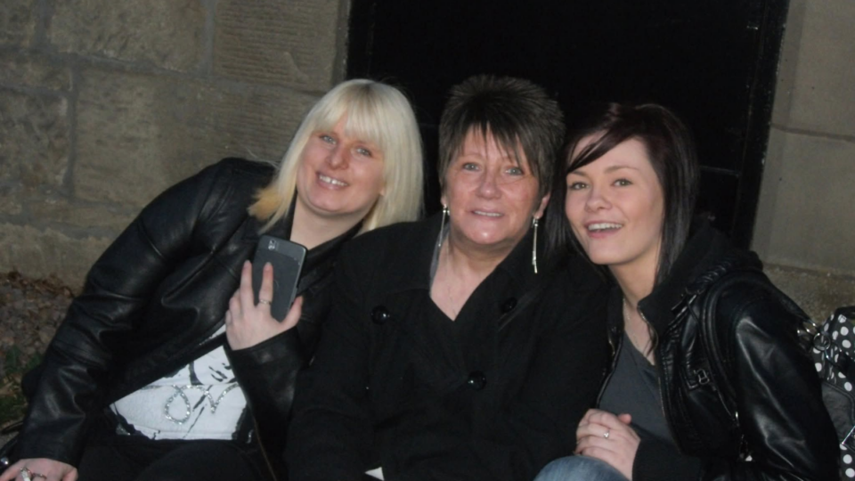 Barbara and her daughters all smiling at the camera.