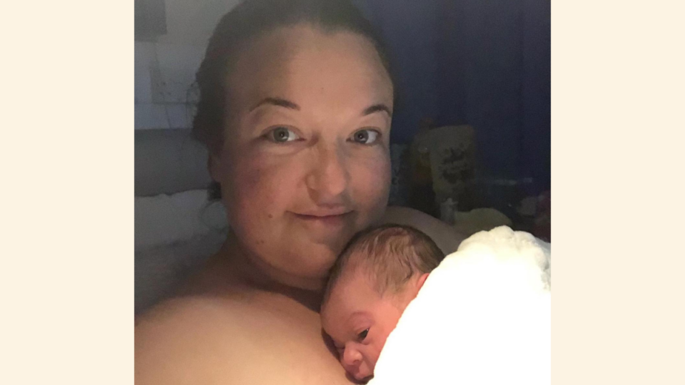 Sarah with Ezrah on her chest