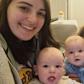 Izzy and Laura holding Alo and Jovie, all smiling at the camera.
