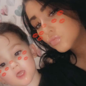 Paige and her son Freddie, with a snapchat filter on their face making at look as though they have lipstick marks on them.