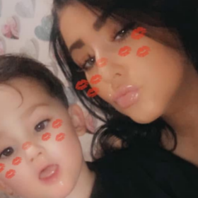 Paige and her son Freddie, with a snapchat filter on their face making at look as though they have lipstick marks on them.