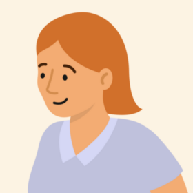 Lady with orange hair and a blue top, smiling.