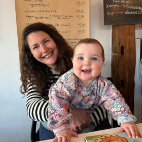 Beth and Joshua at the table, smiling.