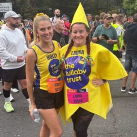 Two female runners in Lullaby yellow. One dressed as a star