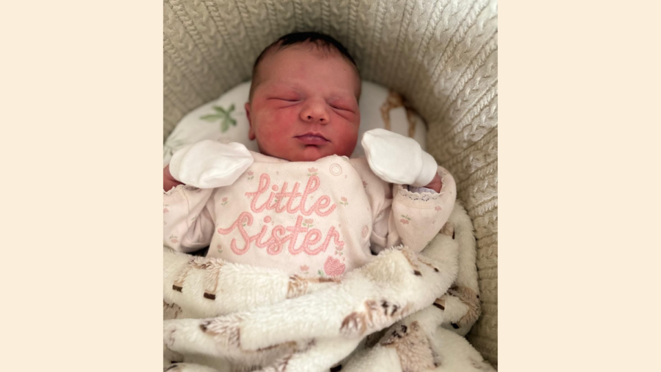 Magnolia after just arriving home. She is wearing a 'little sister' babygrow