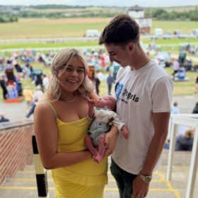 Evie, Harley and Samuel in the audience at an event.