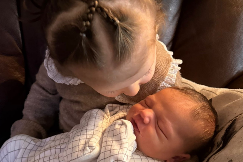 Cordelia with Magnolia on her lap, giving her a kiss.