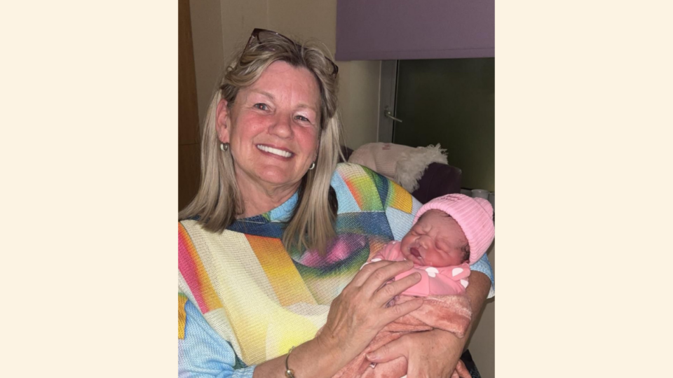 Naleyah wearing a pink hat with Zoey's mum who is smiling at the camera.