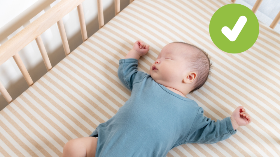 Baby sleeping on their back in a cot. A green tick in the top right corner.